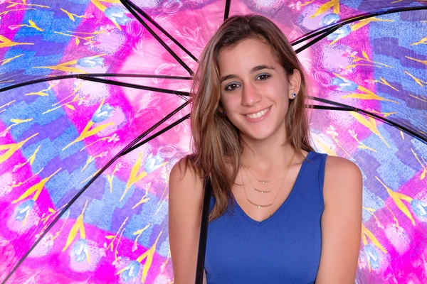 Beautiful hispanic teenage girl holding a colorful umbrella — Stock Photo, Image