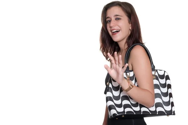 Girl wearing a black dress and a purse smiling and waving goodbye — Stock Photo, Image