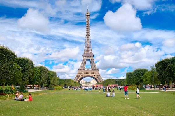 Az Eiffel-torony és a turisták, a Champ de Mars egy nyári napon Párizsban — Stock Fotó