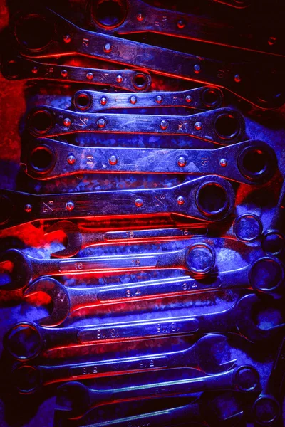 Mechanical or automobile repair tools illuminated in red and blue — Stock Photo, Image