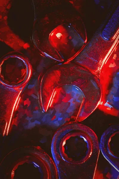 Mechanical or automobile repair tools illuminated in red and blue — Stock Photo, Image