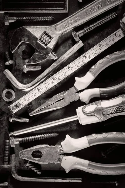 Old tools and screws on a metallic background — Stock Photo, Image