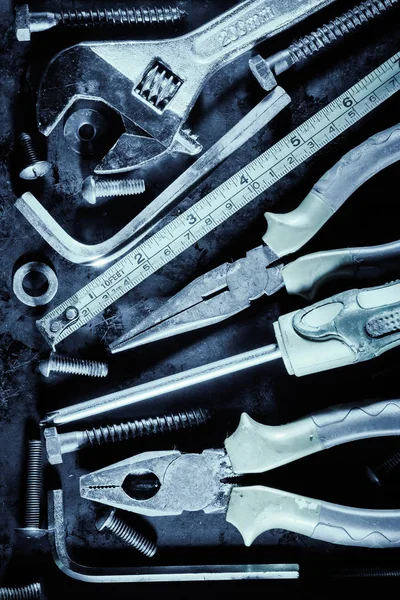 Manual tools and screws with a metallic blue color — Stock Photo, Image