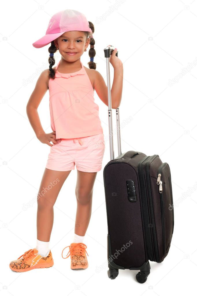 Multiracial small girl carrying a travel suitcase and smiling