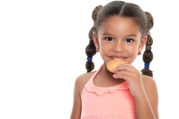 Cute small multiracial girl  eating a cookie - Isolated on white — Stock Photo, Image