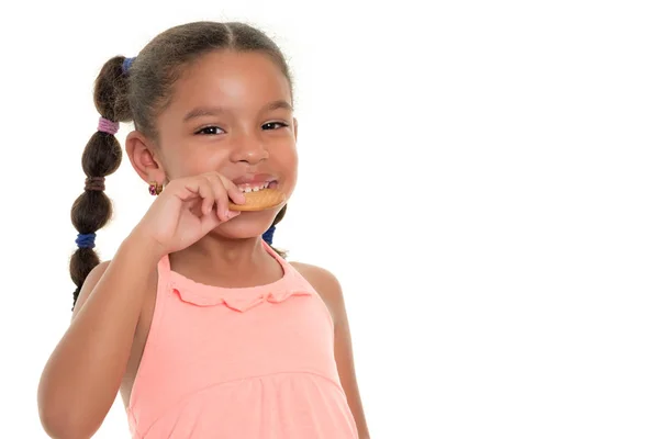 Cute small multiracial girl  eating a cookie - Isolated on white — Stock Photo, Image