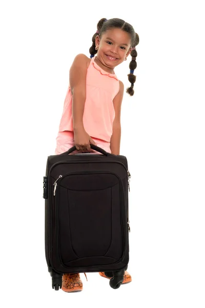 Cute african american girl lifting a heavy suitcase — Stock Photo, Image