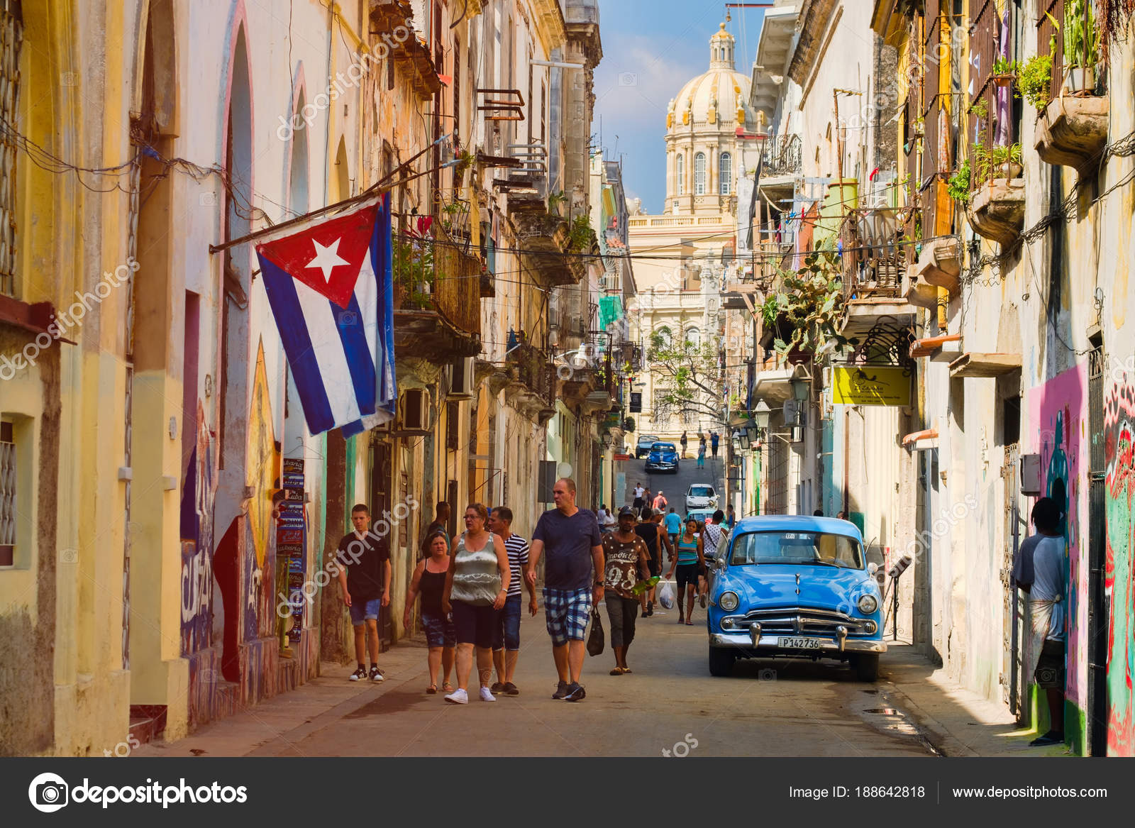 Street scene with cuban flag and classic car in Old Havana Stock