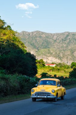 Antique car at a rural road on the famous Vi��ales valley in Cub