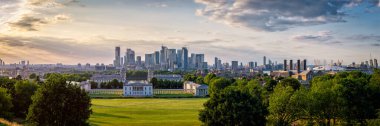 Günbatımında Greenwich Park, Canary Wharf ve Londra rıhtımlarının yüksek çözünürlüklü panoramik görüntüsü