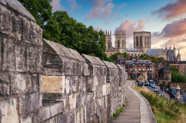 The city of York, its medieval wall and the York Minster at sunset clipart