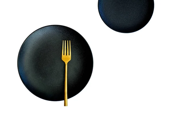 Black plate gold fork — Stock Photo, Image