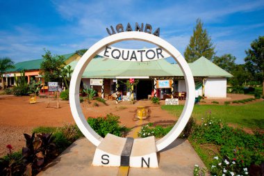 EQUATOR, UGANDA - NOV 1: Equator sign on November 1, 2012 at the Equator, Uganda. Uganda is one of the few countries in the world where the imaginary line that divides the Earth into two halves  passes. clipart