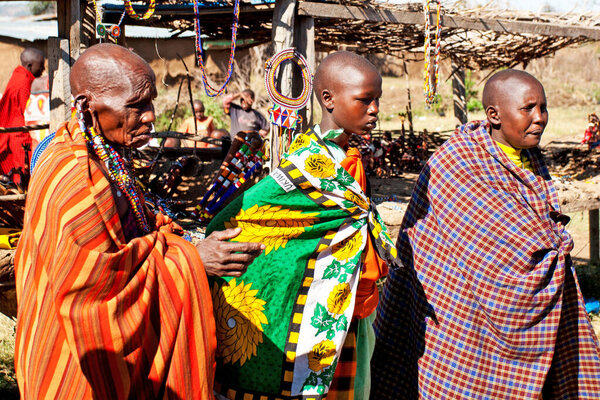 Unidentified Maasai people on Oct 15, 2012 in the Maasai Mara, Kenya. Maasai are a Nilotic ethnic group of semi-nomadic people located in Kenya and northern Tanzania