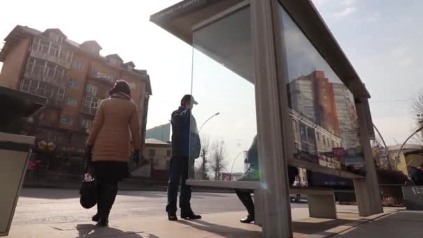Unidentified people at a bus stop in the downtown of Ulaanbaatar, the capital of Mongolia, circa March 2019