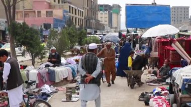 2018 'de Mazar-i-Şerif, Kuzey Afganistan' daki bir pazarda kimliği belirsiz kişiler.