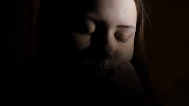 4Gros plan portrait d'une adolescente déprimée dans le noir. 4K UHD .