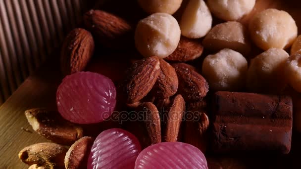 Almonds and sweets on a wooden background. 4K UHD — Stock Video