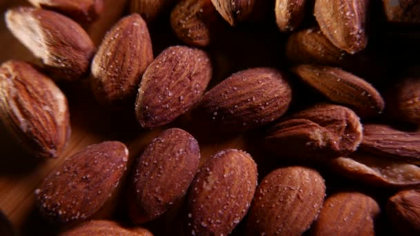 Almonds and sweets on a wooden background. Closeup 4K UHD — Stock Video