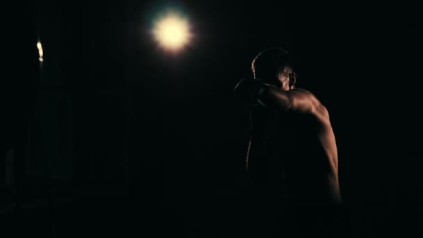 Boxer training in a gym, dramatic lighting. Slow motion — Stock Video