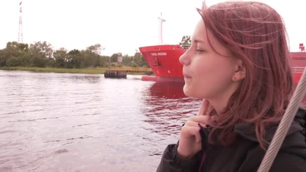 Young girl on a boat enjoys fresh sea air 4K UHD slowmo — Stock Video