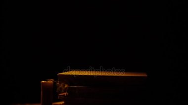 Kitap ve mum. Ateş ve duman. Işık ve darbe mum dışarı. Ağır çekim.