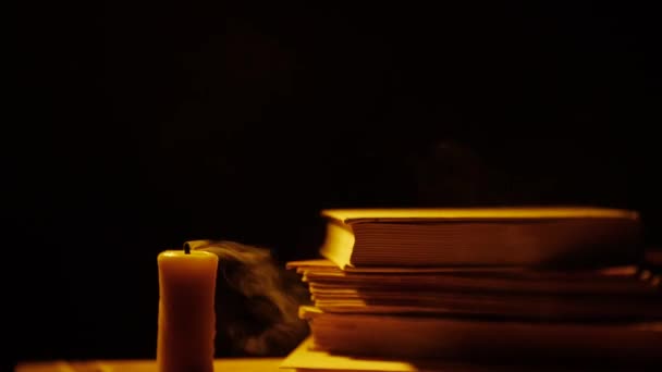 Books and candle. Fire and smoke. — Stock Video