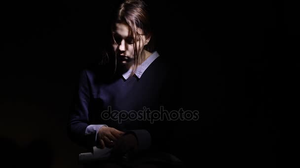 Teen girl reading book at night — Stock Video