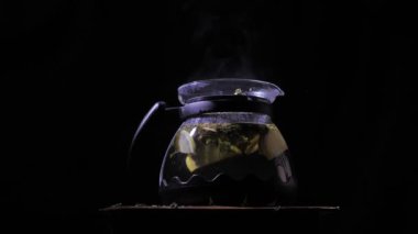Çaydanlık sıcak bir çay ile. Limon bir çaydanlığa düştü.