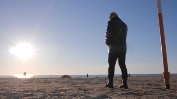 Przedstawcie w sylwecie samotnego mężczyzny na brzegu morza — Wideo stockowe