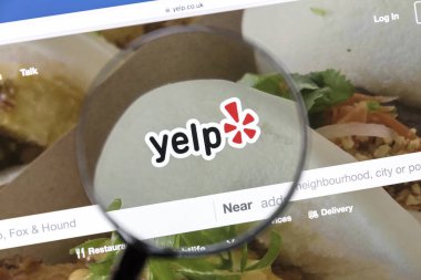 Yelp website under a magnifying glass clipart