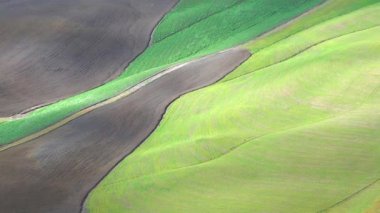 Typical Tuscany landscape in crete Senesi. Clouds shadows moving fast in the field. Italy.