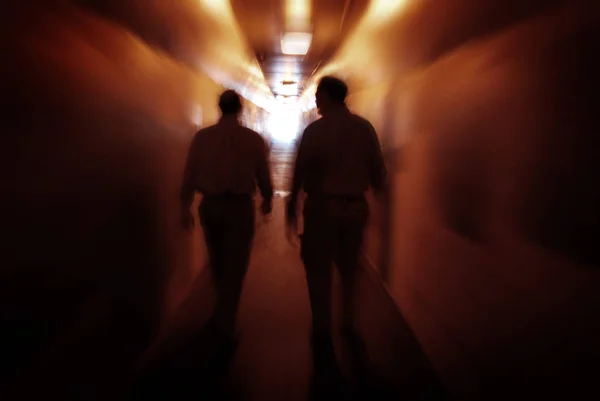 Two men walking through Tunnel Exploring New Places — Stock Photo, Image