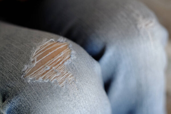 Blue Jeans Fashion With Holes in the Knees Worn Out