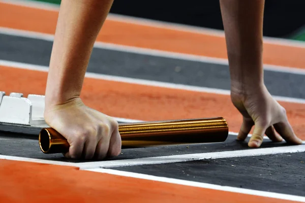 Löpare kör ett Race på banan med stafettpinnen relä Team Poäng — Stockfoto