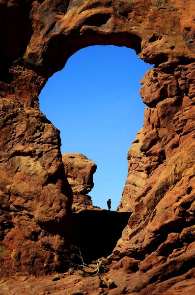 Arco nelle formazioni rocciose del canyon Silhouetter dell'escursionista — Foto Stock