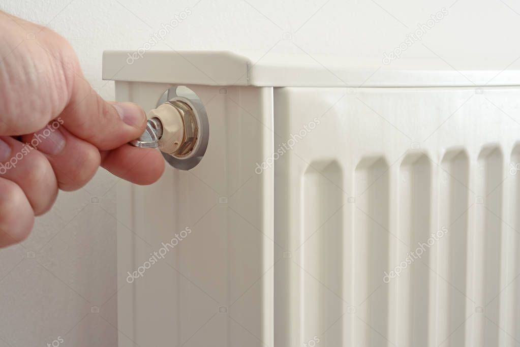 The man venting heating radiator
