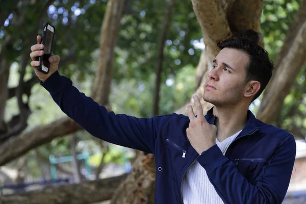 Hip young man posing at the camera selfie — Stock Photo, Image