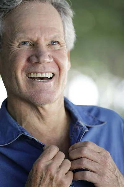 Hombre sonriendo y abotonando su camisa —  Fotos de Stock