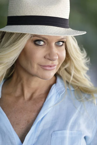 Attractive mature woman in a panama style hat — Stock Photo, Image