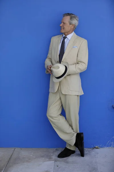 Uomo d'affari su un muro blu — Foto Stock