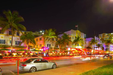 Ocean Drive Miami Beach night scene restaurants and deco hotels clipart