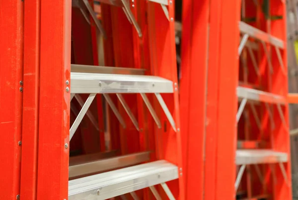 Orange construction ladders at a hardware store — Stock Photo, Image