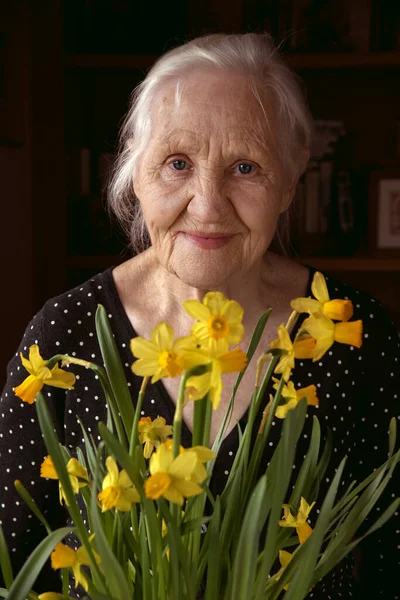 Ηλικιωμένη γυναίκα με λουλούδια — Φωτογραφία Αρχείου