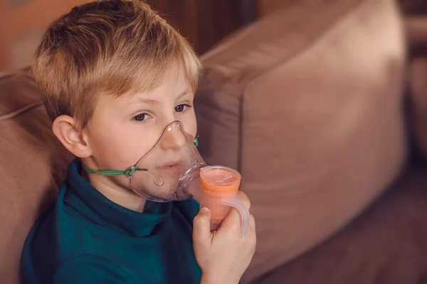 Boy with inhalation mask on face, bronchitis treatment, inhalation treatment