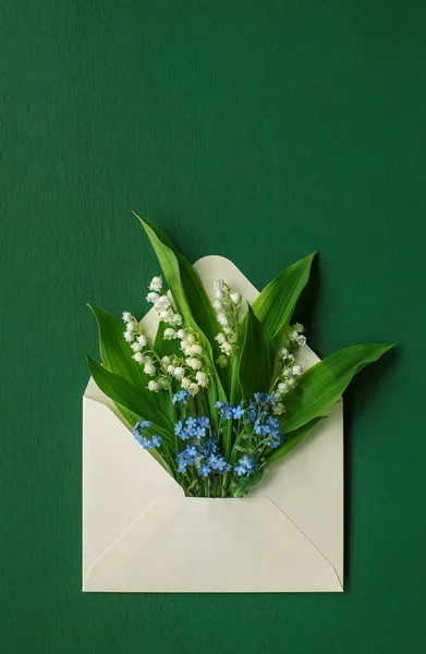 Mother\'s day card with envelope and forget-me-not flowers and lilies of the valley