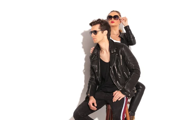 Young couple in leather jackets looking away — Stock Photo, Image