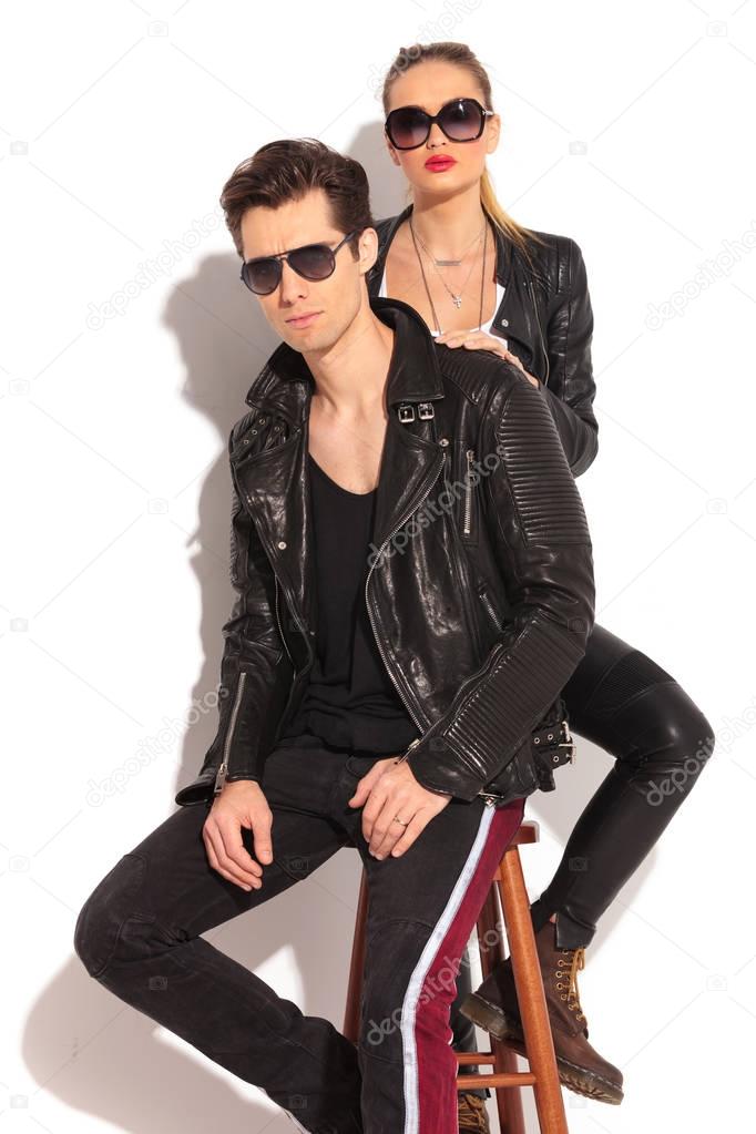 woman in leather jacket standing behind her man