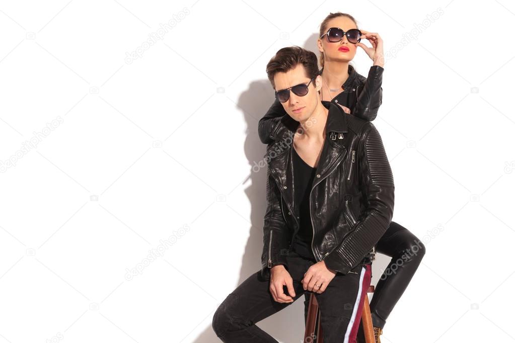 woman in leather jacket leaning her elbow on her man