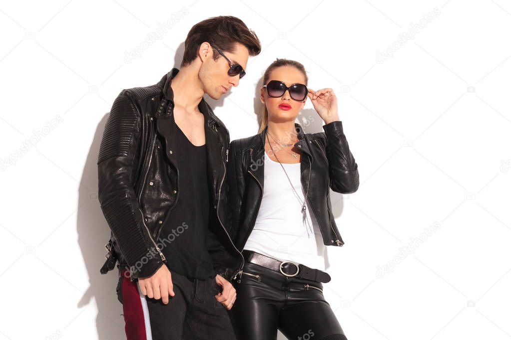 man standing near his girlfriend wearing leather jacket 